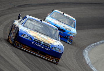 FORT WORTH, TX - NOVEMBER 08:  Kurt Busch, driver of the #2 Miller Lite Dodge, races Marcos Ambrose, driver of the #47 Little Debbie/Kingsford/Clorox Toyota, during the NASCAR Sprint Cup Series Dickies 500 at Texas Motor Speedway on November 8, 2009 in Fort Worth, Texas.  (Photo by Robert Laberge/Getty Images for NASCAR)
