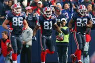 ORCHARD PARK, NY - NOVEMBER 01:  Derek Fine #86, Terrell Owens #81 and Marshawn Lynch #23 of the Buffalo Bills celebrate during the game against the Houston Texans at Ralph Wilson Stadium on November 1, 2009 in Orchard Park, New York. Houston won 31-10. (Photo by Rick Stewart/Getty Images)