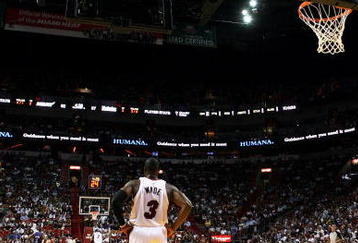 MIAMI - OCTOBER 28:  Dwyane Wade #3 of the Miami Heat watches as his team shoots free-throws on the other end of the court against the New York Knicks at AmericanAirlines Arena on October 28, 2009 in Miami, Florida. The Heat defeated the Knicks 115-93. NOTE TO USER: User expressly acknowledges and agrees that, by downloading and/or using this Photograph, user is consenting to the terms and conditions of the Getty Images License Agreement.  (Photo by Doug Benc/Getty Images)