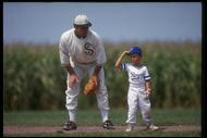 DYERSVILLE, IA - AUGUST 25: A 'ghost player' recreating the role of Chicago White Sox legend Shoeless Joe Jackson plays ball with a young tourist at the baseball field created for the motion picture 'Field of Dreams' on August 25, 1991 in Dyersville, Iowa. Rita and Al Ameskamp who, with Don and Becky Lansing, co-own the site have turned the cornfields and baseball diamond into a summertime tourist attraction, including 'ghost player' reenactments. (Photo by Jonathan Daniel/Getty Images)