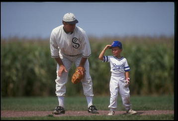 DYERSVILLE, IA - AUGUST 25: A 'ghost player' recreating the role of Chicago White Sox legend Shoeless Joe Jackson plays ball with a young tourist at the baseball field created for the motion picture 'Field of Dreams' on August 25, 1991 in Dyersville, Iowa. Rita and Al Ameskamp who, with Don and Becky Lansing, co-own the site have turned the cornfields and baseball diamond into a summertime tourist attraction, including 'ghost player' reenactments. (Photo by Jonathan Daniel/Getty Images)
