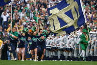 SOUTH BEND, IN - OCTOBER 03: Cheerleaders and the leprechaun mascot of the Notre Dame Fighting Irish run onto the field before a game against the Washington Huskies on October 3, 2009 at Notre Dame Stadium in South Bend, Indiana. Notre Dame defeated Washington 37-30in overtime. (Photo by Jonathan Daniel/Getty Images)