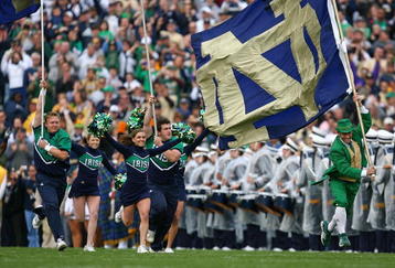 SOUTH BEND, IN - OCTOBER 03: Cheerleaders and the leprechaun mascot of the Notre Dame Fighting Irish run onto the field before a game against the Washington Huskies on October 3, 2009 at Notre Dame Stadium in South Bend, Indiana. Notre Dame defeated Washington 37-30in overtime. (Photo by Jonathan Daniel/Getty Images)