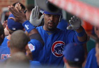 CHICAGO - JUNE 18: Derrek Lee #25 of the Chicago Cubs is congratulated by teammates in the dugout after hitting a three-run home run in the 8th inning against the Chicago White Sox on June 18, 2009 at Wrigley Field in Chicago, Illinois. The Cubs defeated the White Sox 6-5. (Photo by Jonathan Daniel/Getty Images)