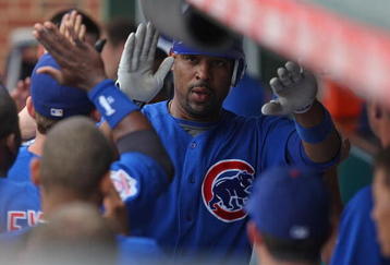CHICAGO - JUNE 18: Derrek Lee #25 of the Chicago Cubs is congratulated by teammates in the dugout after hitting a three-run home run in the 8th inning against the Chicago White Sox on June 18, 2009 at Wrigley Field in Chicago, Illinois. The Cubs defeated the White Sox 6-5. (Photo by Jonathan Daniel/Getty Images)