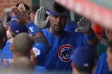CHICAGO - JUNE 18: Derrek Lee #25 of the Chicago Cubs is congratulated by teammates in the dugout after hitting a three-run home run in the 8th inning against the Chicago White Sox on June 18, 2009 at Wrigley Field in Chicago, Illinois. The Cubs defeated the White Sox 6-5. (Photo by Jonathan Daniel/Getty Images)