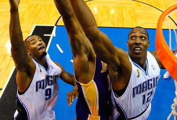 ORLANDO, FL - JUNE 14:  Dwight Howard #12 of the Orlando Magic reaches for a rebound over Andrew Bynum #17 of the Los Angeles Lakers in Game Five of the 2009 NBA Finals on June 14, 2009 at Amway Arena in Orlando, Florida.  NOTE TO USER:  User expressly acknowledges and agrees that, by downloading and or using this photograph, User is consenting to the terms and conditions of the Getty Images License Agreement.  (Photo by Larry W. Smith-Pool/Getty Images)