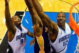 ORLANDO, FL - JUNE 14:  Dwight Howard #12 of the Orlando Magic reaches for a rebound over Andrew Bynum #17 of the Los Angeles Lakers in Game Five of the 2009 NBA Finals on June 14, 2009 at Amway Arena in Orlando, Florida.  NOTE TO USER:  User expressly acknowledges and agrees that, by downloading and or using this photograph, User is consenting to the terms and conditions of the Getty Images License Agreement.  (Photo by Larry W. Smith-Pool/Getty Images)