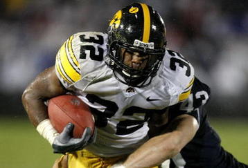 STATE COLLEGE, PA - SEPTEMBER 26:  Adam Robinson #32 of the Iowa Hawkeyes runs for a fourth quarter touchdown trough the tackle of Josh Hull #43 of the Penn State Nittnay Lions on September 26, 2009 at Beaver Stadium in State College, Pennsylvania. Iowa won the game 21-10. (Photo by Gregory Shamus/Getty Images)