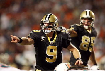MIAMI - OCTOBER 25:  Quarterback Drew Brees #9 of the New Orleans Saints directs his offense pre-snap against the Miami Dolphins at Land Shark Stadium on October 25, 2009 in Miami, Florida. The Saints defeated the Dolphins 46-34.  (Photo by Doug Benc/Getty Images)