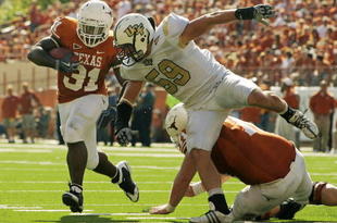 AUSTIN, TX - NOVEMBER 07: Running back Cody Johnson #31 of the Texas Longhorns runs with the ball against linebacker Cory Hogue #59 of the UCF Knights on November 7, 2009 at Darrell K Royal - Texas Memorial Stadium in Austin, Texas. Texas won 35-3. (Photo by Brian Bahr/Getty Images)