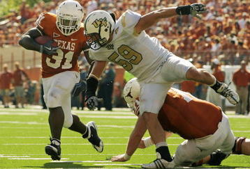 AUSTIN, TX - NOVEMBER 07:  Running back Cody Johnson #31 of the Texas Longhorns runs with the ball against linebacker Cory Hogue #59 of the UCF Knights on November 7, 2009 at Darrell K Royal - Texas Memorial Stadium in Austin, Texas.  Texas won 35-3.  (Photo by Brian Bahr/Getty Images)