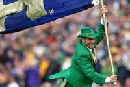 SOUTH BEND, IN - OCTOBER 03: The leprechaun mascot for the Notre Dame Fighting Irish runs onto the field with a flag before a game against the Washington Huskies on October 3, 2009 at Notre Dame Stadium in South Bend, Indiana. Notre Dame defeated Washington 37-30 in overtime. (Photo by Jonathan Daniel/Getty Images)