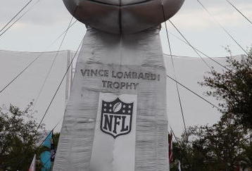 TAMPA, FL - FEBRUARY 01:  Fans walk by a giant inflatable replica of the Vince Lonbardi trophy outside the stadium prior to Super Bowl XLIII between the Arizona Cardinals and the Pittsburgh Steelers on February 1, 2009 at Raymond James Stadium in Tampa, Florida.  (Photo by Streeter Lecka/Getty Images)