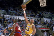 1989: Kareem Abdul- Jabbar of the Los Angeles Lakers makes a layup as Benoit Benjamin of the LA Clippers tries to block him.  Mandatory Credit: Stephen Dunn  /Allsport