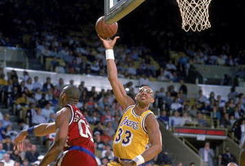 1989: Kareem Abdul- Jabbar of the Los Angeles Lakers makes a layup as Benoit Benjamin of the LA Clippers tries to block him.  Mandatory Credit: Stephen Dunn  /Allsport