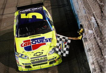 AVONDALE, AZ - APRIL 18:  Mark Martin, driver of the #5 CARQUEST/Kellogg's Chevrolet, receives the checkered flag from NASCAR Official Rodney Wise after winning the NASCAR Sprint Cup Series SUBWAY Fresh Fit 500 at Phoenix International Raceway on April 18, 2009 in Avondale, AZ.  (Photo by Chris Graythen/Getty Images for NASCAR)