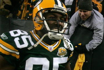 GREEN BAY, WI - JANUARY 12:  Wide receiver Greg Jennings #85 of the Green Bay Packers smiles after catching a two-yard touchdown pass in the second quarter against the Seattle Seahawks during the NFC divisional playoff game on January 12, 2008 at Lambeau Field in Green Bay, Wisconsin. The Packers defeated the Seahawks 42-20 to advance to the NFC championship game. (Photo by Jonathan Daniel/Getty Images)
