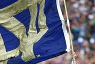SOUTH BEND, IN - OCTOBER 03: The leprechaun mascot for the Notre Dame Fighting Irish runs onto the field with a flag before a game against the Washington Huskies on October 3, 2009 at Notre Dame Stadium in South Bend, Indiana. Notre Dame defeated Washington 37-30 in overtime. (Photo by Jonathan Daniel/Getty Images)