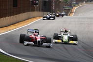 SAO PAULO, BRAZIL - OCTOBER 18:  Kamui Kobayashi (L) of Japan and Toyota and Jenson Button (R) of Great Britain and Brawn GP race into turn one during the Brazilian Formula One Grand Prix at the Interlagos Circuit on October 18, 2009 in Sao Paulo, Brazil.  (Photo by Mark Thompson/Getty Images)