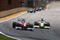 SAO PAULO, BRAZIL - OCTOBER 18:  Kamui Kobayashi (L) of Japan and Toyota and Jenson Button (R) of Great Britain and Brawn GP race into turn one during the Brazilian Formula One Grand Prix at the Interlagos Circuit on October 18, 2009 in Sao Paulo, Brazil.  (Photo by Mark Thompson/Getty Images)