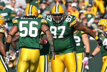 GREEN BAY, WI - OCTOBER 18: Johnny Jolly #97 and  Nick Barnett #56 of the Green Bay Packers celebrate a defensive stop against the Detroit Lions at Lambeau Field on October 18, 2009 in Green Bay, Wisconsin. The Packers defeated the Lions 26-0. (Photo by Jonathan Daniel/Getty Images)