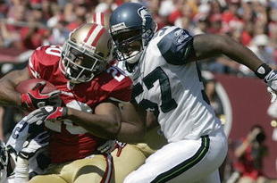 SAN FRANCISCO - SEPTEMBER 20:  Cornerback Allen Rossum #20 of the San Francisco 49ers tries to break a tackle by cornerback Kelly Jennings #21 and linebacker David Hawthorne #57 of the Seattle Seahawks in the first quarter action during the home opener at Candlestick Park on September 20, 2009 in San Francisco, California.  (Photo by David Paul Morris/Getty Images)
