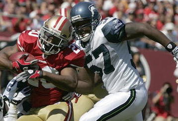 SAN FRANCISCO - SEPTEMBER 20:  Cornerback Allen Rossum #20 of the San Francisco 49ers tries to break a tackle by cornerback Kelly Jennings #21 and linebacker David Hawthorne #57 of the Seattle Seahawks in the first quarter action during the home opener at Candlestick Park on September 20, 2009 in San Francisco, California.  (Photo by David Paul Morris/Getty Images)