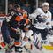 UNIONDALE, NY - NOVEMBER 02: Shawn Horcoff #10 of the Edmonton Oilers is moved out of the crease by Radek Martinek #24 of the New York Islanders at the Nassau Coliseum on November 2, 2009 in Uniondale, New York. (Photo by Bruce Bennett/Getty Images)