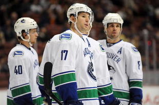 ANAHEIM, CA - OCTOBER 30:  Michael Grabner #40 , Ryan Kesler #17 and Willie Mitchell #8 of the Vancouver Canucks look on prior to a faceoff during their game against the Anaheim Ducks at the Honda Center on October 30, 2009 in Anaheim, California. The Ducks defeated the Canucks 7-2.  (Photo by Harry How/Getty Images)