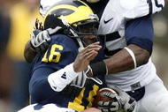 ANN ARBOR, MI - OCTOBER 24:  Denard Robinson #16 of the Michigan Wolverines is tackled by Bani Gbadyu #15 and Josh Hull #43 of the Penn State Nittany Lions on October 24, 2009 at Michigan Stadium in Ann Arbor, Michigan.  (Photo by Gregory Shamus/Getty Images)