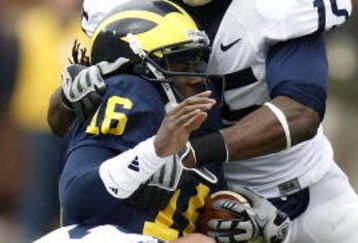 ANN ARBOR, MI - OCTOBER 24:  Denard Robinson #16 of the Michigan Wolverines is tackled by Bani Gbadyu #15 and Josh Hull #43 of the Penn State Nittany Lions on October 24, 2009 at Michigan Stadium in Ann Arbor, Michigan.  (Photo by Gregory Shamus/Getty Images)