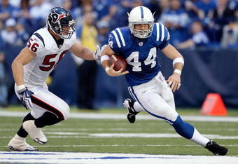 INDIANAPOLIS - NOVEMBER 08: Dallas Clark #44 of the Indianapolis Colts runs with the ball while defended by Brian Cushing #56 of the Houston Texans  during the NFL game at Lucas Oil Stadium on November 8, 2009 in Indianapolis, Indiana.The Colts won 20-17.  (Photo by Andy Lyons/Getty Images)