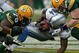 GREEN BAY, WI - OCTOBER 18: Kevin Smith #34 of the Detroit Lions is tackled by Ryan Pickett #79 and A.J. Hawk #50 of the Green Bay Packers at Lambeau Field on October 18, 2009 in Green Bay, Wisconsin. The Packers defeated the Lions 26-0. (Photo by Jonathan Daniel/Getty Images)