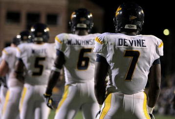 BOULDER, CO - SEPTEMBER 18:  Quarterback Pat White #5 of the West Virginia Mountaineers along with Will Johnson #6 and Noel Devine #7 line up in the back field against the Colorado Buffaloes at Folsom Field on September 18, 2008 in Boulder, Colorado. Colorado defeated West Virginia 17-14 in overtime.  (Photo by Doug Pensinger/Getty Images)
