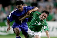 DUBLIN, IRELAND - SEPTEMBER 7: Republic of Ireland winger Andy Reid tussles with French player Florent Malouda during the World Cup Group 4 Qualifying Match between Ireland and France at Lansdowne Road on September 7, 2005 in Dublin, Ireland/ (Photo by Stu Forster/Getty Images)