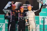 SHANGHAI, CHINA - APRIL 19:  Race winner Sebastian Vettel (C) of Germany and Red Bull Racing celebrates with second placed team mate Mark Webber (L) of Australia and Red Bull Racing and third placed Jenson Button (R) of Great Britain and Brawn GP on the podium after the Chinese Formula One Grand Prix at the Shanghai International Circuit on April 19, 2009 in Shanghai, China.  (Photo by Mark Thompson/Getty Images)