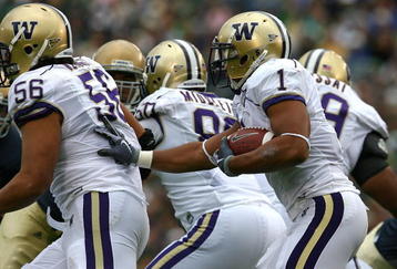 SOUTH BEND, IN - OCTOBER 03: Chris Polk #1 of the Washington Huskies follows blocker Senio Kelemete #56 against the Notre Dame Fighting Irish on October 3, 2009 at Notre Dame Stadium in South Bend, Indiana. Notre Dame defeated Washington 37-30 in overtime. (Photo by Jonathan Daniel/Getty Images)