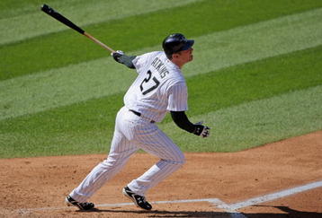 DENVER - OCTOBER 01:  Garrett Atkins #27 of the Colorado Rockies hits an RBI double off of starting pitcher Manny Parra #26 of the Milwaukee Brewers to score Todd Helton and give the Rockies a 3-0 lead in the third inning at Coors Field on October 1, 2009 in Denver, Colorado.  (Photo by Doug Pensinger/Getty Images)