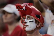 FAYETTEVILLE, AR - SEPTEMBER 2:  A male fan of the Arkansas Razorbacks looks on wearing face paint and a hog hat during the game against the University of Southern California Trojans on September 2, 2006 at Donald W. Reynolds Razorback Stadium in Fayetteville, Arkansas.  Southern California won 50-14.  (Photo by Brian Bahr/Getty Images)
