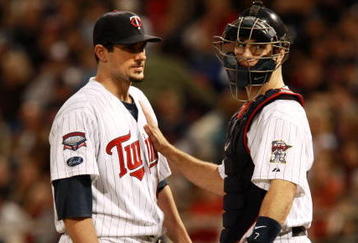 MINNEAPOLIS, MN - OCTOBER 11: Pitcher Carl Pavano #48 of the Minnesota Twins talks with catcher Joe Mauer #2 after Jorge Posada  the New York Yankees hit a home run in the seventh inning to take a 2-1 lead in Game Three of the ALDS during the 2009 MLB Playoffs at the Hubert H. Humphrey Metrodome on October 11, 2009 in Minneapolis, Minnesota. (Photo by Genevieve Ross/Getty Images)