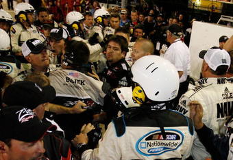 CONCORD, NC - MAY 24:  Crew members of both Brad Keselowski, driver of the #88 NAVY Chevrolet, and Denny Hamlin, driver of the #20 Z-Line Designs Toyota, argue on pit road after an altercation following the NASCAR Nationwide Series CARQUEST Auto Parts 300 on May 24, 2008 at Lowe's Motor Speedway in Concord, North Carolina.  (Photo by Jason Smith/Getty Images for NASCAR)