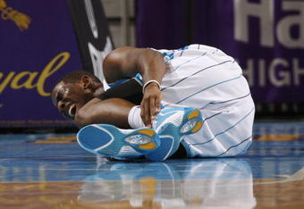 NEW ORLEANS - NOVEMBER 13:  Chris Paul #3 of the New Orleans Hornets lies on the court in pain during the game against the Portland Trail Blazers at New Orleans Arena on November 13, 2009 in New Orleans, Louisiana.  NOTE TO USER: User expressly acknowledges and agrees that, by downloading and or using this photograph, User is consenting to the terms and conditions of the Getty Images License Agreement. (Photo by Chris Graythen/Getty Images)