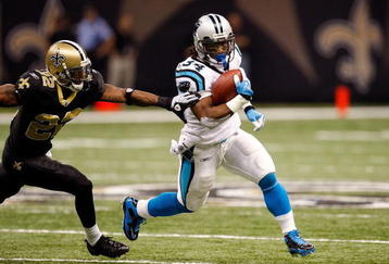 NEW ORLEANS - NOVEMBER 08:  Running back DeAngelo Williams #34 of the Carolina Panthers runs  the ball against Tracy Porter #22 of the New Orleans Saints at Louisiana Superdome on November 8, 2009 in New Orleans, Louisiana.  (Photo by Ronald Martinez/Getty Images)