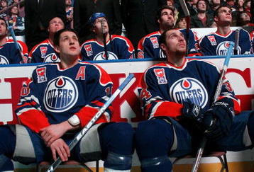 EDMONTON, CANADA - FEBRUARY 27:  Shawn Horcoff #10 and Fernando Pisani #34 of the Edmonton Oilers watch from the ice with teammates behind them on the Oilers bench as a video plays on the jumbotron during a ceremony to raise former Oilers great Mark Messier's #11 banner to the rafters of Rexall Place prior to the Oilers game against the Phoenix Coyotes on February 27, 2007 at Rexall Place in Edmonton, Alberta, Canada.  (Photo by Tim Smith/Getty Images)   