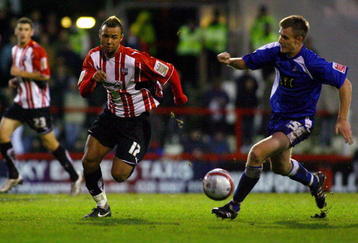LONDON, ENGLAND - NOVEMBER 14:  John Bostock of Brentford battles for the ball with Tony Craig of Millwall during the Coca-Cola League One match between Brentford and Millwall at Griffin Park on November 14, 2009 in London, England.  (Photo by Dean Mouhtaropoulos/Getty Images)