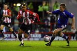 LONDON, ENGLAND - NOVEMBER 14:  John Bostock of Brentford battles for the ball with Tony Craig of Millwall during the Coca-Cola League One match between Brentford and Millwall at Griffin Park on November 14, 2009 in London, England.  (Photo by Dean Mouhtaropoulos/Getty Images)