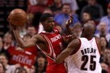 PORTLAND, OR - APRIL 28:  Aaron Brooks #0 of the Houston Rockets passes the ball  against Travis Outlaw #25 of the Portland Trail Blazers during Game 5 of the Western Conference Quarterfinals of the NBA Playoffs on April 28, 2009 at the Rose Garden in Portland, Oregon. NOTE TO USER: User expressly acknowledges and agrees that, by downloading and or using this Photograph, user is consenting to the terms and conditions of the Getty Images License Agreement.  (Photo by Jonathan Ferrey/Getty Images)