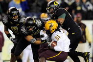 EUGENE,OR - NOVEMBER 14: Linebacker Eddie Pleasant #11, linebacker Spencer Paysinger #35 and linebacker Kenny Rowe #58 of the Oregon Ducks gang up to tackle running back Dimitri Nance #31of the Arizona State Sun Devils in the third quarter of the game at Autzen Stadium on November 14, 2009 in Eugene, Oregon. Oregon Defeated arizona State 44-21.(Photo by Steve Dykes/Getty Images)