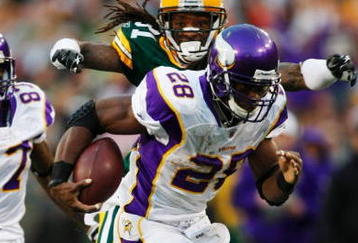 GREEN BAY, WI - NOVEMBER 01:  Al Harris #31 of the Green Bay Packers tackles Adrian Peterson #28 of the Minnesota Vikings during the third quarter of the game at Lambeau Field on November 1, 2009 in Green Bay, Wisconsin. (Photo by Scott Boehm/Getty Images)